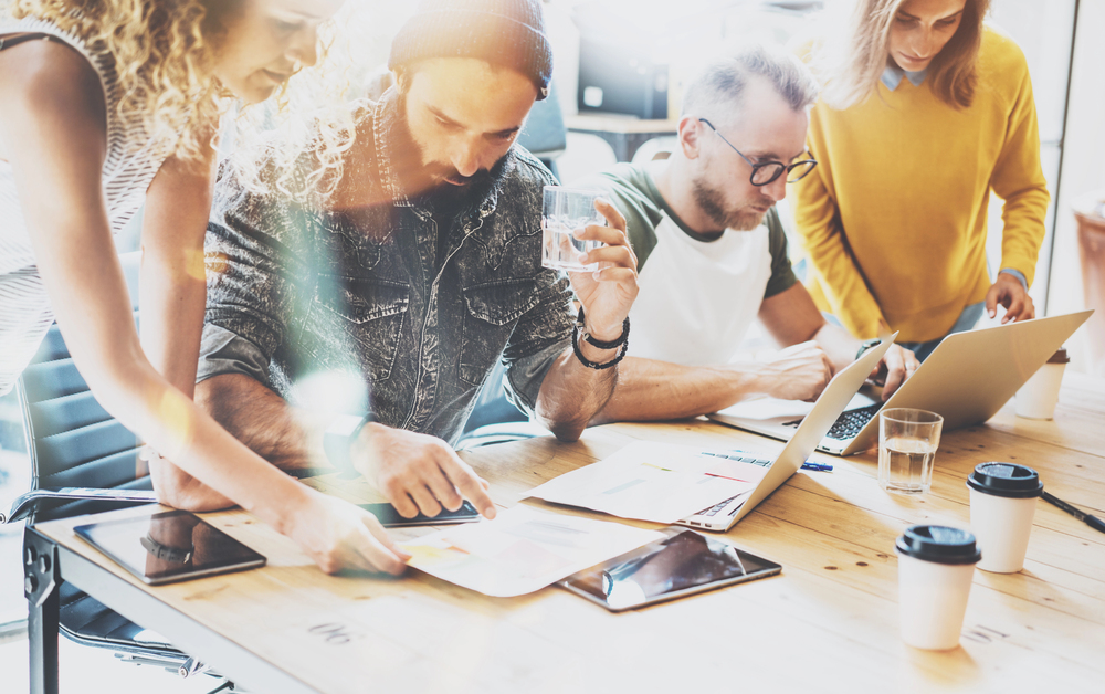 Creative marketing team reviewing ideas around a table